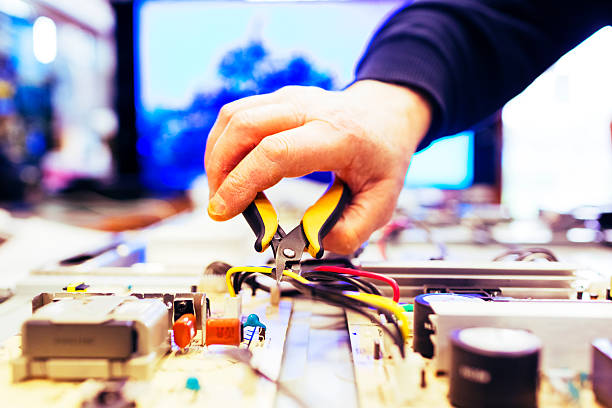 TV repair man working on big plasma televsion.